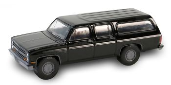 GREEN28150-D - CHEVROLET Suburban C10 custom deluxe 1985 zwart uit de BLACK BANDIT serie in blisterverpakking